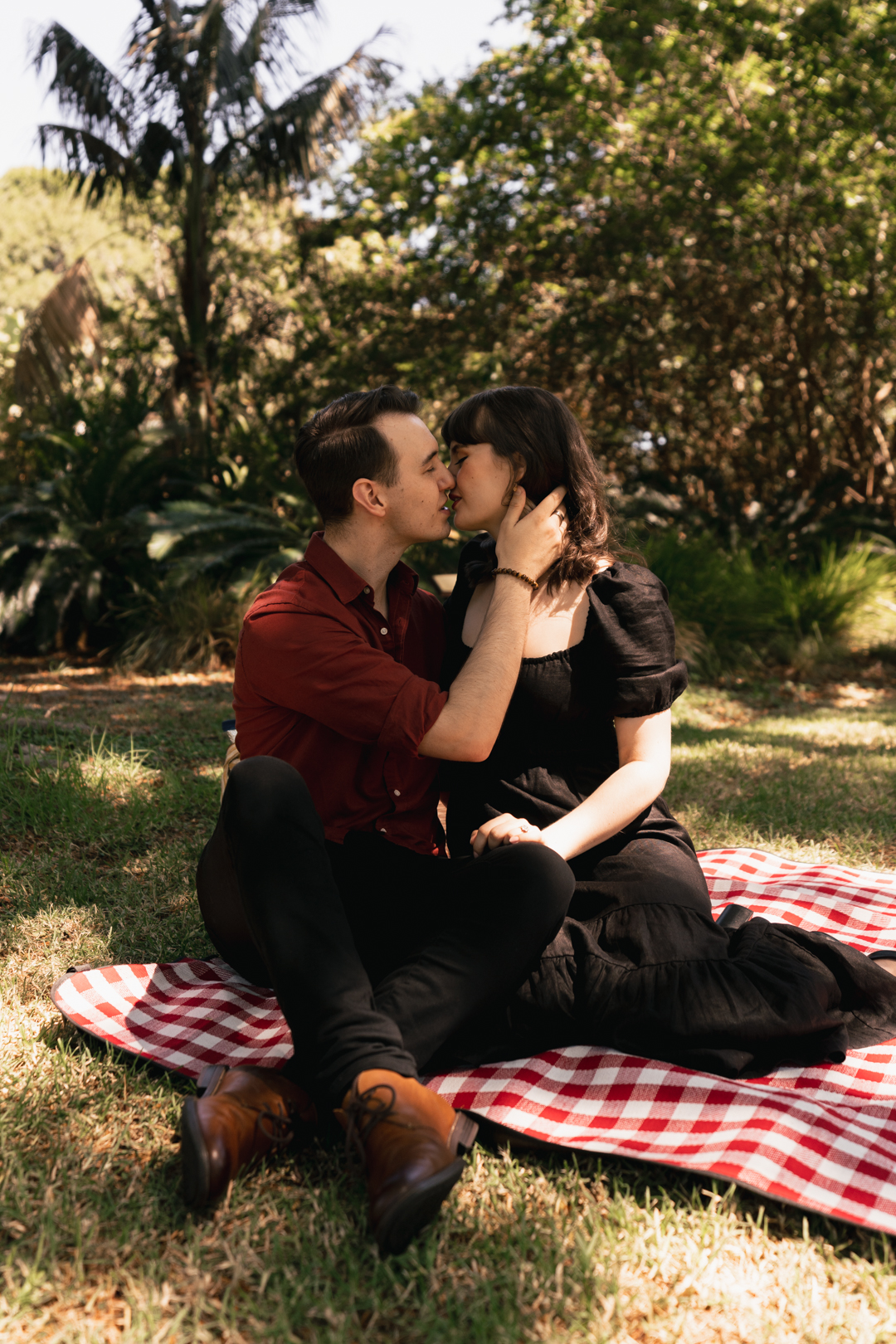 Couple engaged during picnic at Adelaide Botanic Gardens 
